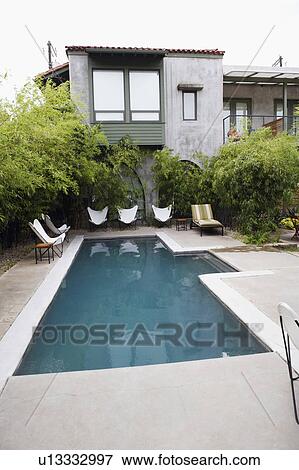 Stock Photo - Swimming pool in front of a building. Fotosearch