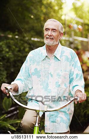 Mature man riding a bicycle View Large Photo Image Stock Image - Mature man riding a bicycle. Fotosearch