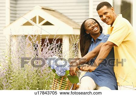 Portrait of a mature man carrying a mid adult woman on a bicycle View Large Photo Image Stock Photography - Portrait of a mature man carrying a mid adult woman on a bicycle. Fotosearch
