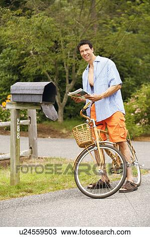 Portrait of a mature man standing with a bicycle near a mailbox View Large Photo Image Stock Image - Portrait of a mature man standing with a bicycle near a mailbox. Fotosearch