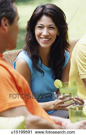 Stock Image - Mature couple holding glasses of lemonade. Fotosearch