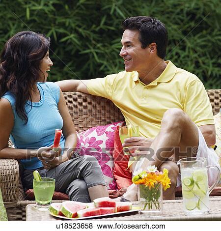 Mature man holding a glass of lemonade with a mature woman holding a slice of water melon beside him View Large Photo Image Stock Photo - Mature man holding a glass of lemonade with a mature woman holding a slice of water melon beside him. Fotosearch