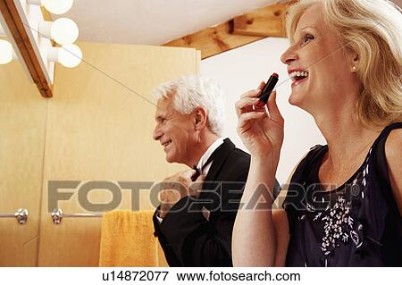 Close-up of a mature couple dressing up in the bathroom and laughing View Large Photo Image Stock Photo - Close-up of a mature couple dressing up in the bathroom and laughing. Fotosearch