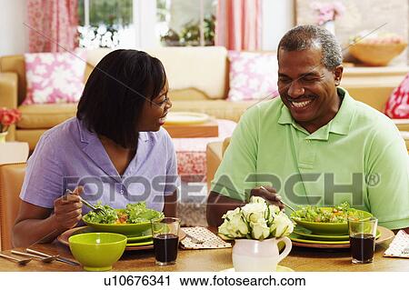 Close-up of a mature couple eating salad and smiling View Large Photo Image Stock Image - Close-up of a mature couple eating salad and smiling. Fotosearch