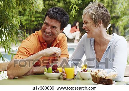 Close-up of a mature couple having breakfast View Large Photo Image Stock Photo - Close-up of a mature couple having breakfast. Fotosearch