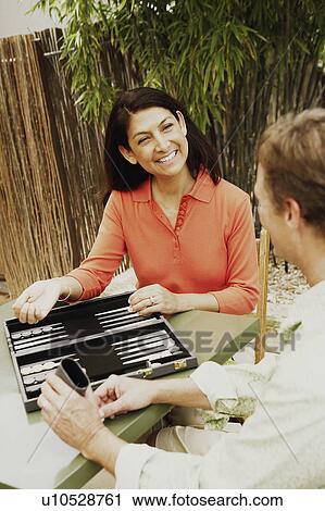 Stock Image - Mature couple playing backgammon. Fotosearch