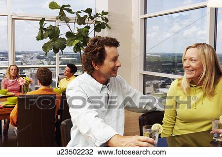 Mature couple sitting at a counter and holding glasses of lemonade View Large Photo Image Stock Image - Mature couple sitting at a counter and holding glasses of lemonade. Fotosearch
