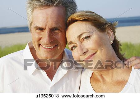 Portrait of a mature couple smiling on the beach View Large Photo Image Stock Photo - Portrait of a mature couple smiling on the beach. Fotosearch