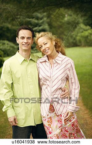 Stock Photo - Portrait of a mature couple standing and smiling. Fotosearch