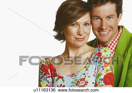 Stock Photograph - Portrait of a mid adult couple smiling. Fotosearch