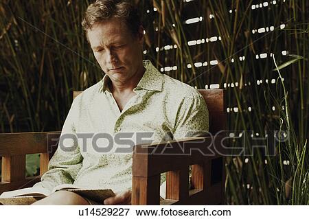 Stock Photo - Close-up of a mature man reading a book. Fotosearch