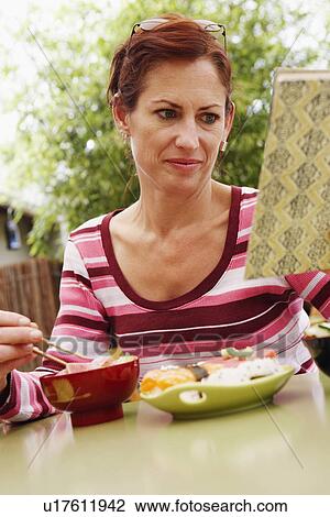 Close-up of a mature woman reading View Large Photo Image Stock Image - Close-up of a mature woman reading. Fotosearch