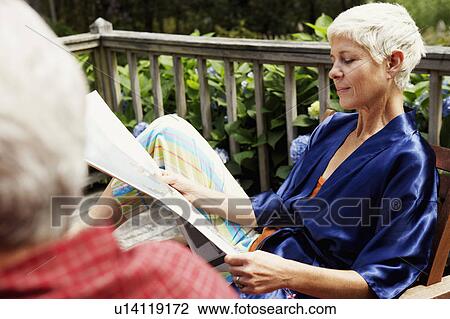 Close-up of a senior woman reading a newspaper View Large Photo Image Stock Image - Close-up of a senior woman reading a newspaper. Fotosearch