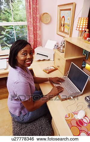 Portrait of a mature woman using a laptop and smiling View Large Photo Image Stock Photograph - Portrait of a mature woman using a laptop and smiling. Fotosearch