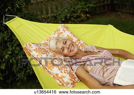 Portrait of a senior woman lying in a hammock and smiling View Large Photo Image Stock Photograph - Portrait of a senior woman lying in a hammock and smiling. Fotosearch