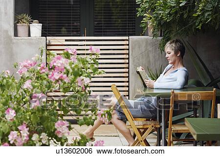 Side profile of a mature woman reading a book View Large Photo Image Stock Photograph - Side profile of a mature woman reading a book. Fotosearch