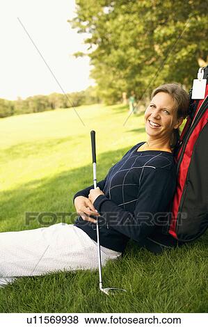 Portrait of a mature woman leaning against a golf bag View Large Photo Image Stock Photo - Portrait of a mature woman leaning against a golf bag. Fotosearch