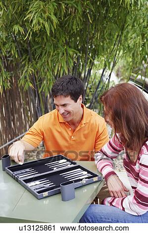 High angle view of a mature woman and a mature man playing backgammon View Large Photo Image Stock Image - High angle view of a mature woman and a mature man playing backgammon. Fotosearch