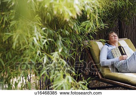 Mature woman sleeping on a lounge chair View Large Photo Image Stock Photography - Mature woman sleeping on a lounge chair. Fotosearch