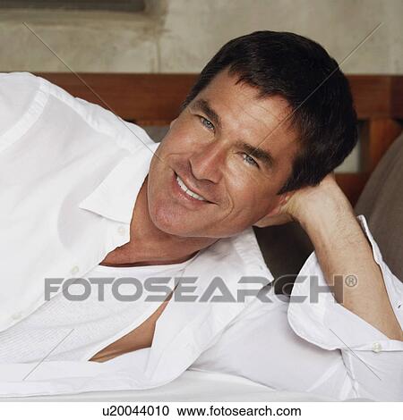 Portrait of a mature man lying down View Large Photo Image Stock Image - Portrait of a mature man lying down. Fotosearch