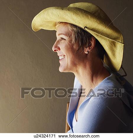 Stock Image - Side profile of a mature woman smiling. Fotosearch