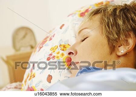 Close-up of a mature woman sleeping on the bed View Large Photo Image Stock Photography - Close-up of a mature woman sleeping on the bed. Fotosearch
