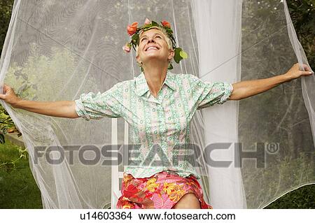 Picture - Close-up of a senior woman sitting and smiling. Fotosearch