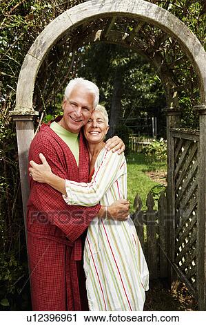 Portrait of a mature man and a senior woman embracing each other and smiling View Large Photo Image Stock Image - Portrait of a mature man and a senior woman embracing each other and smiling. Fotosearch