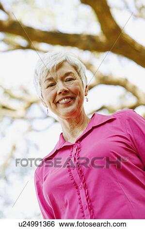 Portrait of a senior woman smiling View Large Photo Image Stock Photograph - Portrait of a senior woman smiling. Fotosearch