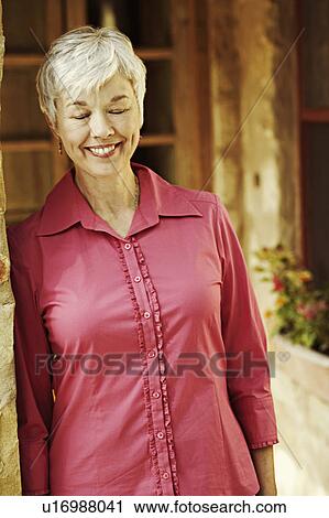 Senior woman smiling with her eyes closed View Large Photo Image Stock Image - Senior woman smiling with her eyes closed. Fotosearch