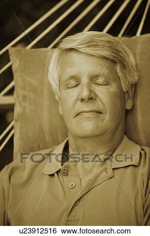 Close-up of a mature man sleeping in a hammock View Large Photo Image Stock Photograph - Close-up of a mature man sleeping in a hammock. Fotosearch