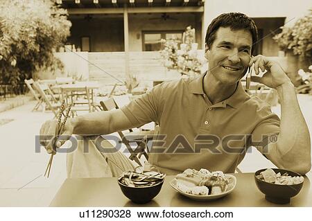Stock Photo - Close-up of a mature man talking on a mobile phone. Fotosearch