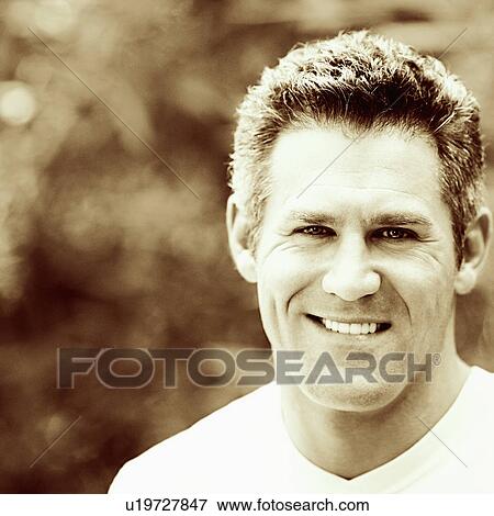 Stock Photo - Close-up of a mid adult man smiling. Fotosearch