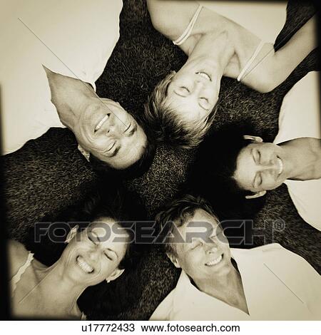 Stock Image - High angle view of two mature couples smiling. Fotosearch