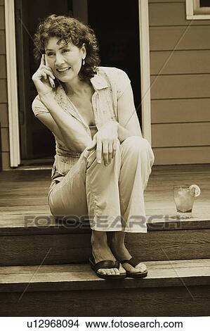 Picture - Mature woman talking on a mobile phone. Fotosearch