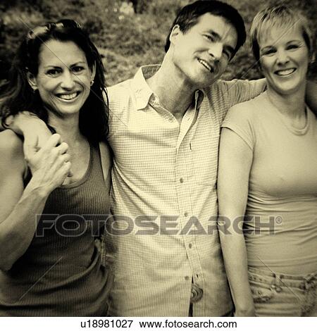 Stock Photo - Portrait of a mature man and two mature women standing together and smiling. Fotosearch