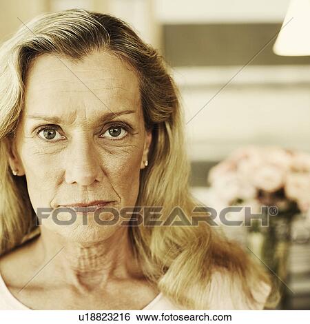 Stock Photograph - Portrait of a mature woman looking serious. Fotosearch
