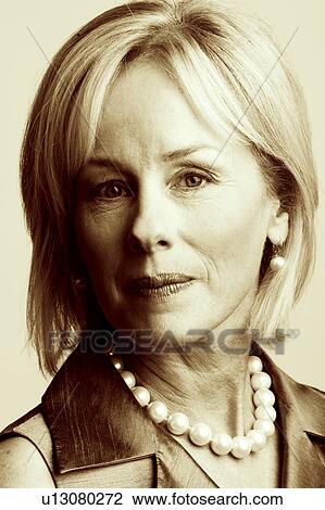 Portrait of a mature woman smirking View Large Photo Image Stock Image - Portrait of a mature woman smirking. Fotosearch