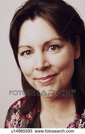 Stock Image - Portrait of a mature woman smirking. Fotosearch
