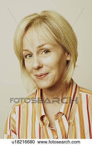 Stock Image - Portrait of a mature woman smirking. Fotosearch