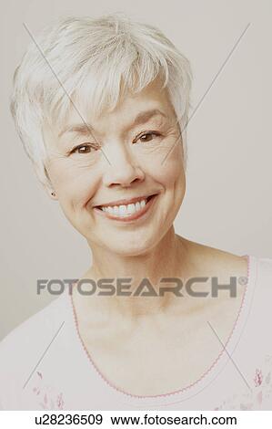 Portrait of a senior woman smiling View Large Photo Image Stock Photo - Portrait of a senior woman smiling. Fotosearch