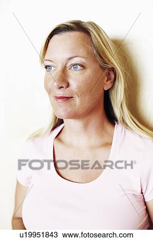 Stock Image - Close-up of a mature woman smirking. Fotosearch