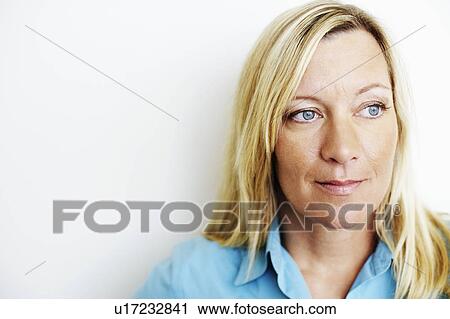 Stock Image - Close-up of a mature woman thinking. Fotosearch