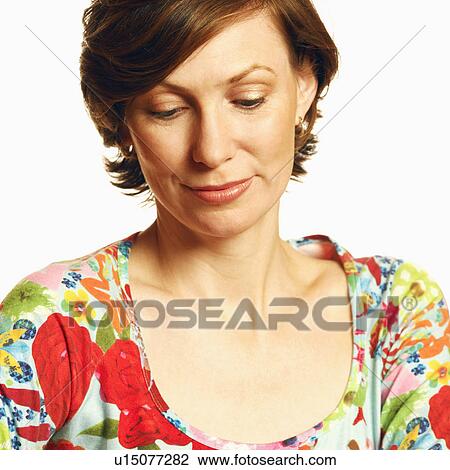 Stock Image - Close-up of a mid adult woman looking down. Fotosearch