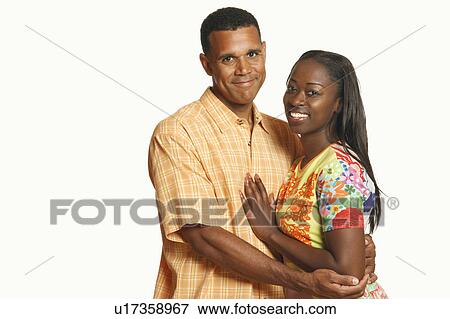 Portrait of a mature man embracing a mid adult woman and smiling View Large Photo Image Stock Photo - Portrait of a mature man embracing a mid adult woman and smiling. Fotosearch