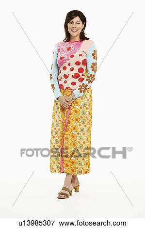 Portrait of a mature woman standing and smiling View Large Photo Image Stock Photo - Portrait of a mature woman standing and smiling. Fotosearch