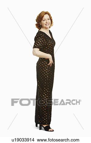 Portrait of a mature woman standing with her hand on her hip and smiling View Large Photo Image Picture - Portrait of a mature woman standing with her hand on her hip and smiling. Fotosearch