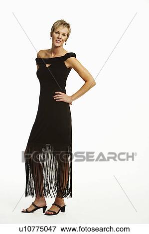 Portrait of a mature woman standing with her hands on her hip View Large Photo Image Stock Photo - Portrait of a mature woman standing with her hands on her hip. Fotosearch