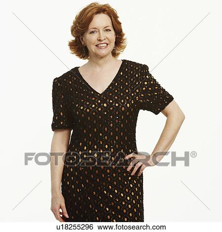 Portrait of a mature woman standing with her hand on her hip and smiling View Large Photo Image Stock Photograph - Portrait of a mature woman standing with her hand on her hip and smiling. Fotosearch