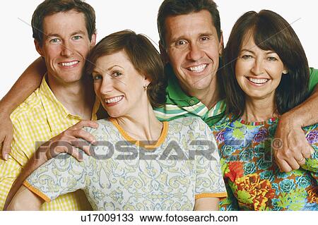 Portrait of a mid adult couple and a mature couple posing and smiling View Large Photo Image Stock Image - Portrait of a mid adult couple and a mature couple posing and smiling. Fotosearch